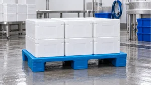 Illustrative blue flat-deck three-runner plastic pallet with sealed cartons in a seafood packing area