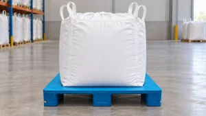 Illustrative blue flat-deck three-runner plastic pallet carrying one white FIBC bulk bag